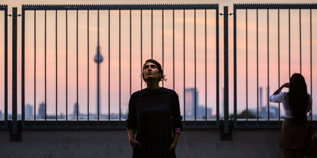 Im Vordergrund Fatma Aydemir, im Hintergrund Berlin bei Sonnenuntergang