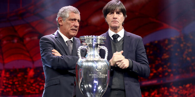 Zwei Trainer stehen hinter dem EM-Pokal