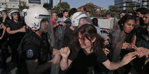 Zusammenstoß von Polizisten in Kampfuniform und Demonstrantinnen
