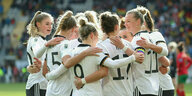Deutsche Fußballnationalspielerinnen stehen im Kreis und umarmen sich