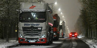 Lastwagen steht im nächtlichen Schnee