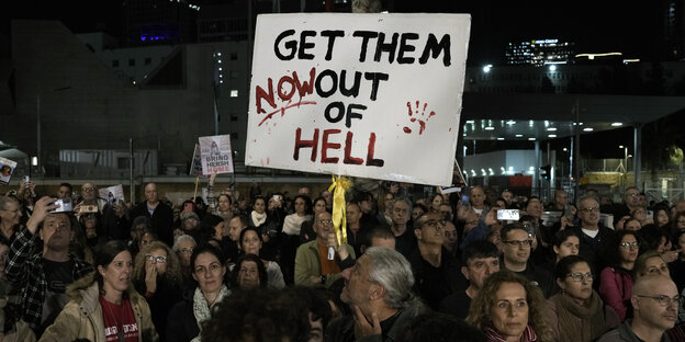 People at night at a demonstration in Israel on January 20.