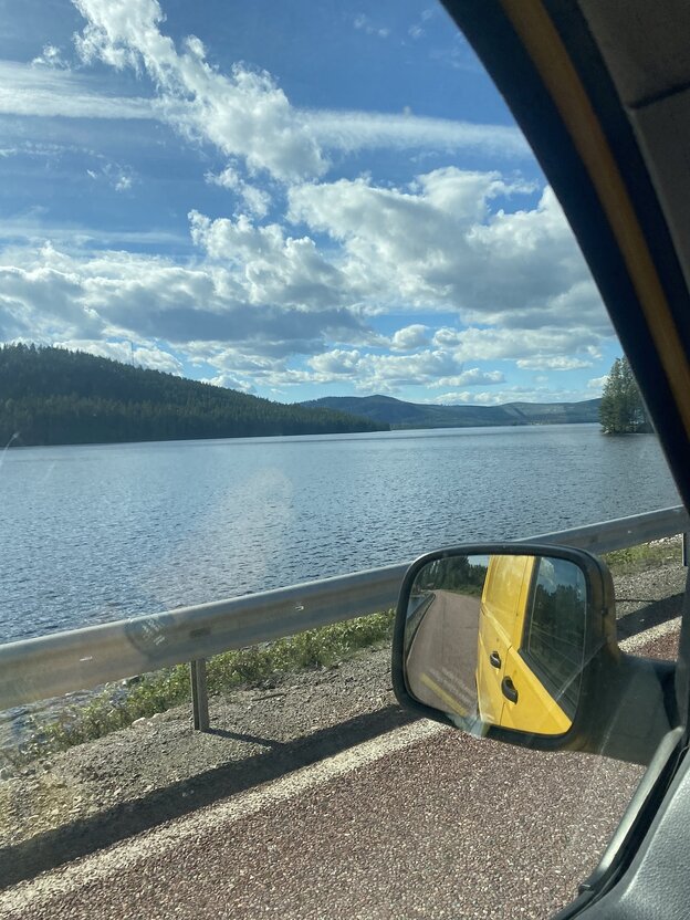 View from a car window of a summer lake landscape