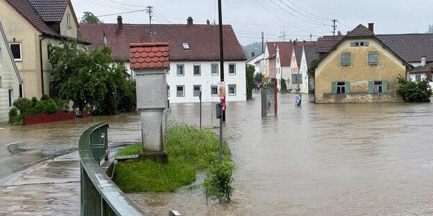 Eine überflutete Straße nach starken Regenfällen in Fischach bei Augsburg.