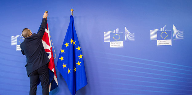 EU-Mitarbeiter richtet Großbritannien- und Europa-Flagge