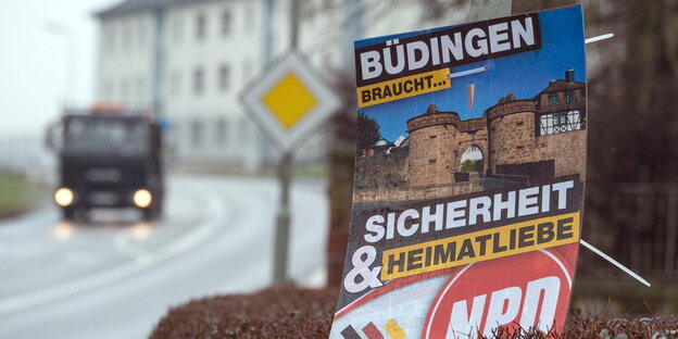 Ein Plakat der NPD mit der Aufschrift "Büdingen braucht Sicherheit und Heimatliebe" neben einer Straße