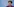 Eine Frau, es ist Beata Szydlo, steht vor einer blauen Wand