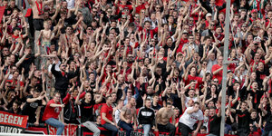 Fans des 1. FC Nürnberg feiern im Stadion den Sieg