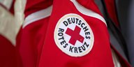 Das Logo des Roten Kreuzes auf einer roten Jacke
