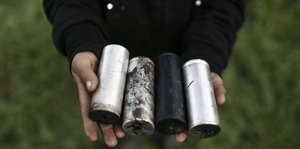 Eine Person hält Tränengasgranaten in den Händen