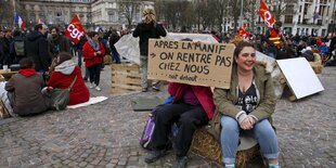 Menschen mit Plakaten und Fahnen auf einem großen Platz