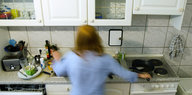 Eine verschwommene Person hantiert in einer Küche