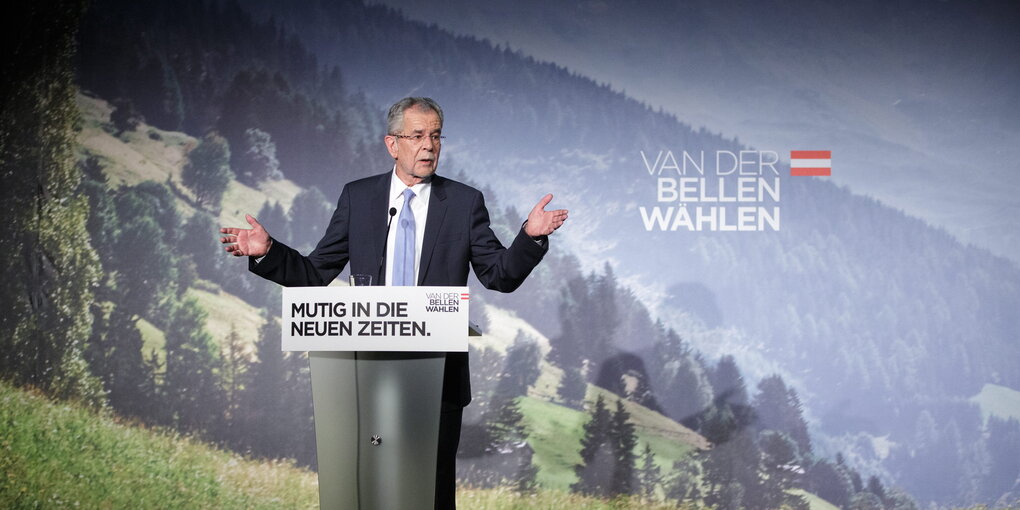 Ein Mann mit Brille steht an einem Rednerpult. Es ist Alexander van der Bellen