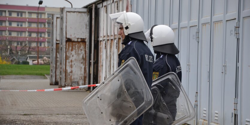 Zwei Polizisten mit Helm und Schild