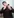 ein junger Mann blickt in sein Handy und fasst sich ans Kinn