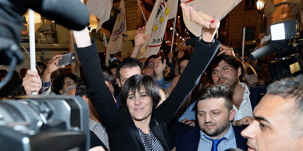 Eine Frau, es ist Chiara Appendino, feiert in einer Menschenmenge