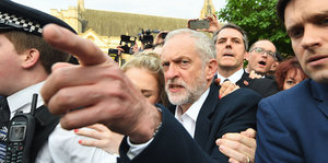 Labour-Chef Jeremy Corbyn steht in einer Menschenmenge und zeigt mit dem Finger
