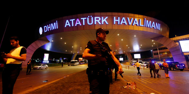 Ein bewaffneter Polizist vor dem Eingang des Flughafens