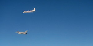 Ein Flugzeug der Royal Air Force und ein russisches Kampfflugzeug vor blauem Himmel