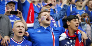 drei Fans der isländischen Mannschaft singen gemeinsam wahrscheinlich die isländische Nationalhymne im Stadion