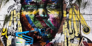 Riesiges Wand-Graffiti mit einem buntbemalten Gesicht