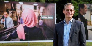 Müller vor Plakaten