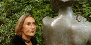 Die Schriftstellerin Angelika Schrobsdorff neben einer weiblichen Steinskulptur