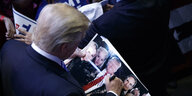 Donald Trump signiert sein Bild