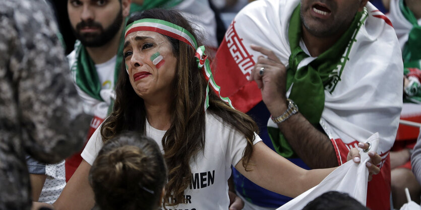 Ein weiblicher Sportfan mit grün-weiß-roter Bemalung