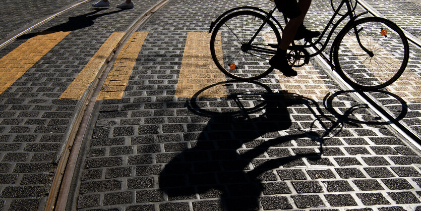 Fahrradfahrer, der über einen gelben Zebrastreifen fährt.