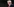 Donald Trump von der Seite mit weit offenem Mund und erhobener Hand