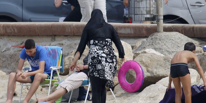 Frau in Burkini am Strand