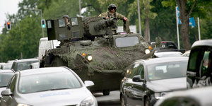Ein Militärfahrzeug zwischen Autos