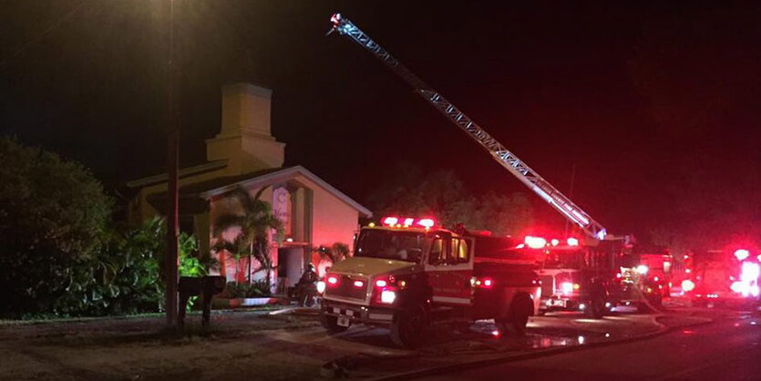 Feuerwehrautos stehen vor der äußerlich unbeschädigten Moschee