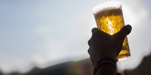 Eine Hand hält ein Glas Bier