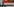 Eine Frau geht an einem Nachtzug der Deutschen Bahn entlang, der am Gleis steht.