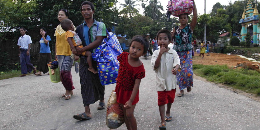 Eine Rohingya-Familie flieht zu Fuß