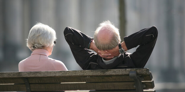 zwei alte Menschen sitzen auf einer Parkbank zwei alte Menschen sitzen auf einer Parkbank