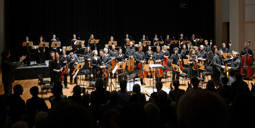 Die Dresdner Sinfoniker hell erleuchtet in einem sonst dunklen Raum