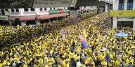 Menschen protestieren in gelben T-Shirts gegen den Premierminister von Malaysia