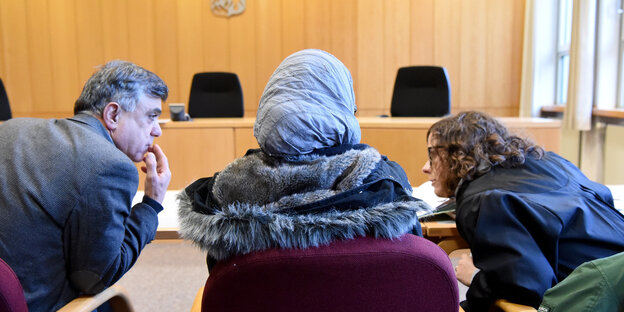 Die Asylbewerberin aus Syrien sitzt mit ihrer Anwältin und ihrem Übersetzer im Verhandlungssaal des Oberverwaltungsgerichtes in Schwesig