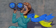 Wandmalerei: Frau schaut durch Fernglas mit EU-Sternen