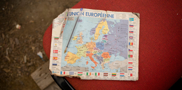 Eine zerfledderte Europakarte liegt auf einem roten Polster