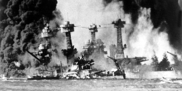 Ein schwarz-weiß Bild zeigt brennende Schiffe