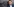 Daniel Harrich steht vor einem Schießstand