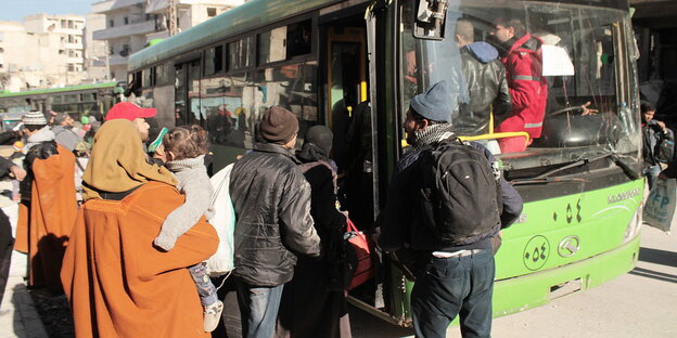 Menschen drängen sich an der Eingangstür eines Busses