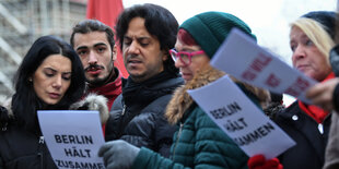 Menschen mit Zetteln in den Händen am Breitscheidplatz