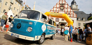 Ein VW-Bus steht auf einem Martkplatz
