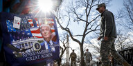 Ein Soldat geht auf der National Mall in Washington an einem Plakat von Trump vorbei