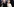 Hillary und Bill Clinton stehen nebeneinander. Hillary winkt und verzieht das Gesicht